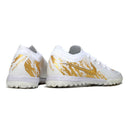 Chuteira Society Nike Phantom GX2 Elite Branca e Dourada